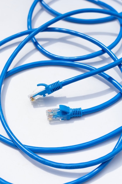 Połączenie sieciowe LAN ethernet niebieskie kable na białym tle.