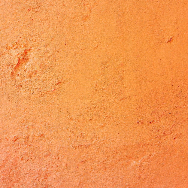 Pomarańczowy betonowy mur rocznika tekstury tło