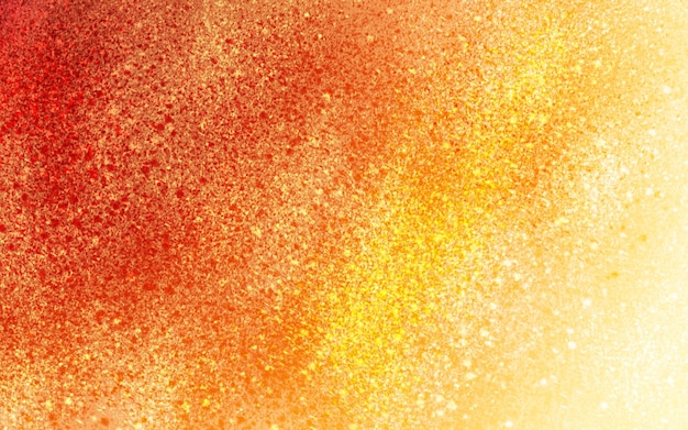 Zdjęcie pomarańczowy i żółty brokatowy tło z teksturą złotego brokatu.