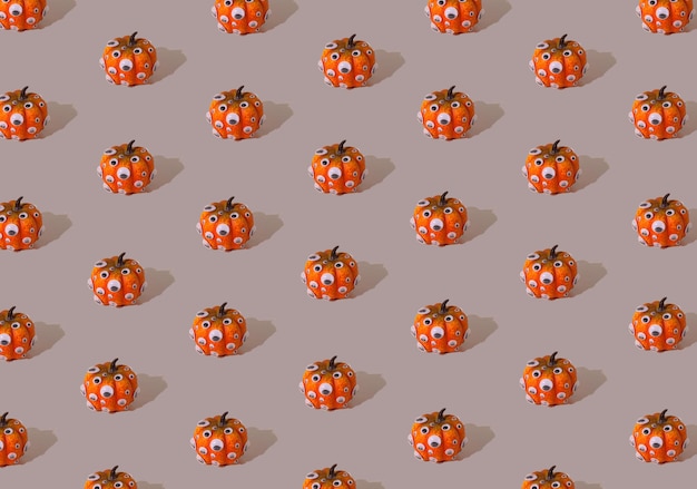 Zdjęcie pomarańczowy wzór dyni z oczami na szarym tle koncepcja halloween