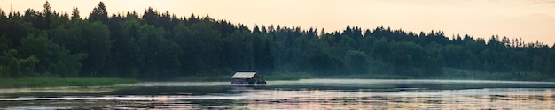 Poranek nad rzeką wcześnie rano trzciny mgła mgła i tafla wody na rzece Piękny naturalny krajobraz Letnie podróże