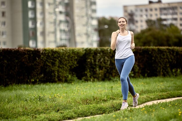 Zdjęcie poranny jogging młodej kobiety w parku miejskim