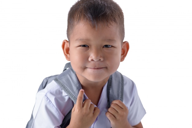 Portret azjatykcia kraj chłopiec w mundurku szkolnym odizolowywającym na bielu