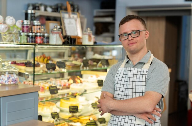 Zdjęcie portret białego mężczyzny z zespołem downa pracującego w kawiarni