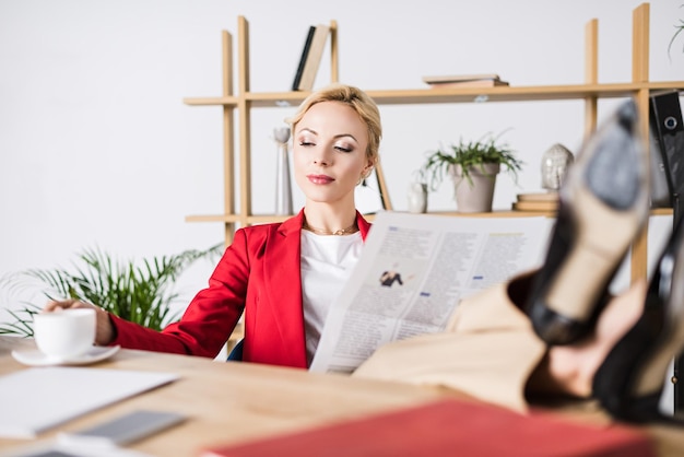 Zdjęcie portret bizneswoman z gazetą w miejscu pracy