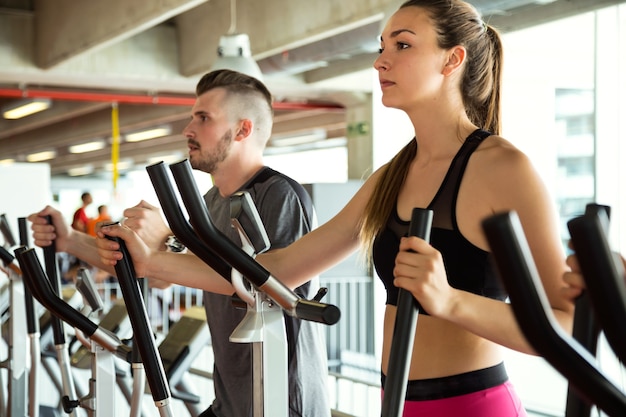 Portret grupy ludzi ćwiczących nogi robi treningu cardio w siłowni.