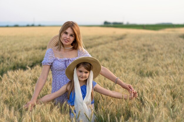 Zdjęcie portret matki i córki stojących na farmie na tle nieba