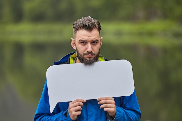 Zdjęcie portret młodego mężczyzny stojącego na zewnątrz