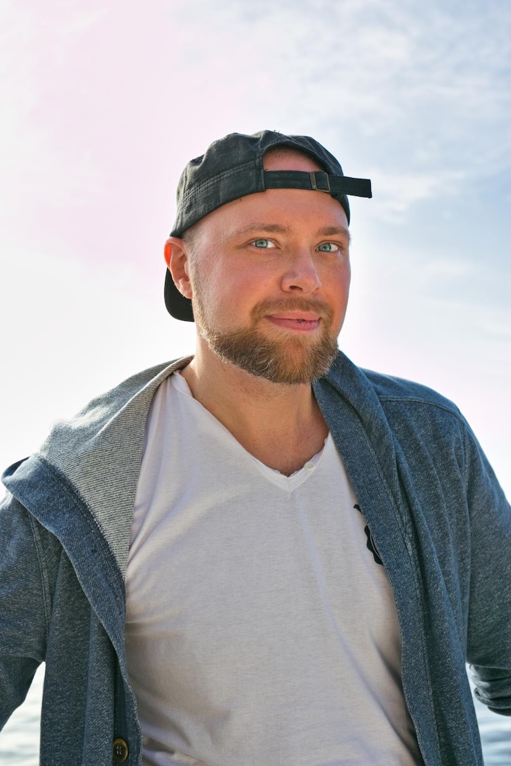 Zdjęcie portret młodego mężczyzny stojącego przed niebem
