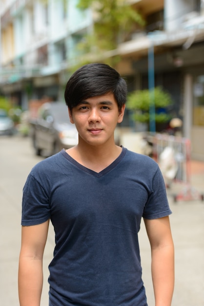 Zdjęcie portret młodego przystojnego mężczyzny filipino na ulicach na zewnątrz