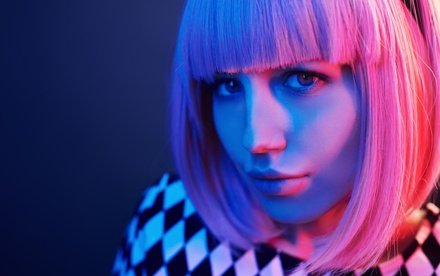 Portret młodej dziewczyny z blond włosami w czerwonym i niebieskim neonu w studio