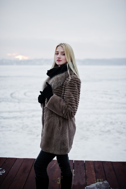 Portret Młodej Kobiety Blondynka Elegancji W Futrze Na Molo, Mglista Rzeka Na Lodzie Zimowym.