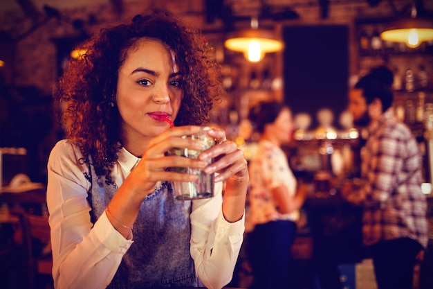 Portret młodej kobiety pijącej napój koktajlowy
