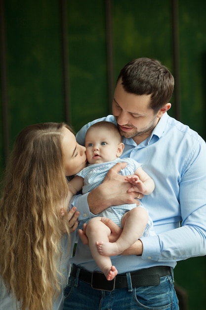 Portret młodej rodziny z małą córeczką w ramionach