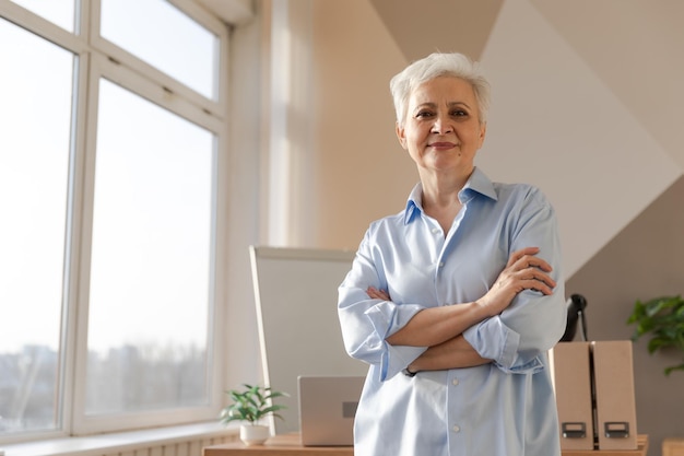 Portret pewnej siebie stylowej europejskiej starszej kobiety w średnim wieku w miejscu pracy Stylowa starsza dojrzała siwowłosa dama bizneswoman z lat 60. w nowoczesnym biurze Lider szefa nauczyciel pracownik zawodowy