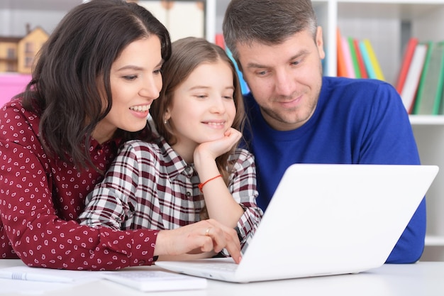 Portret rodziny z córką za pomocą laptopa