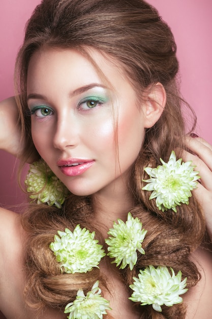 Portret romantyczna młoda kobieta z zielony kwiat i makijaż patrząc. Fotografia mody wiosennej. Inspiracja wiosną i latem.