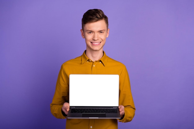 Portret szczęśliwego wesołego mężczyzny pokazującego ekran laptopa patrzącego na kamerę na białym tle nad jasnym tłem