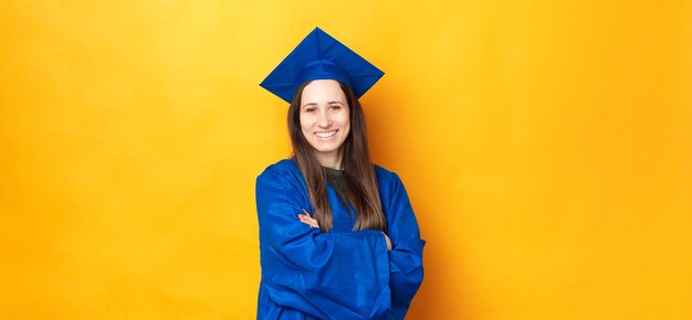 Portret uśmiechnięta młoda kobieta wesoły ukończeniu studiów i noszenie niebieskiej szaty