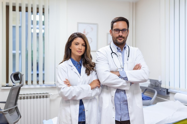 Zdjęcie portret uśmiechniętych młodych lekarzy stojących razem portret personelu medycznego w nowoczesnym szpitalu uśmiechający się do kamery