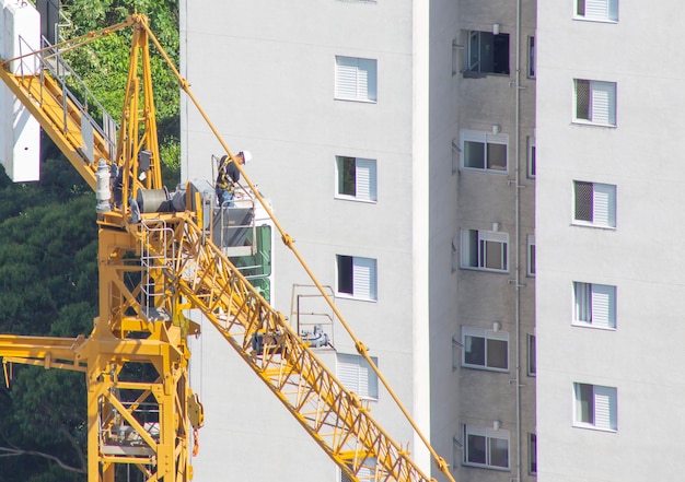 Pracownik na górze kabiny dźwigu na placu budowy Widok z góry