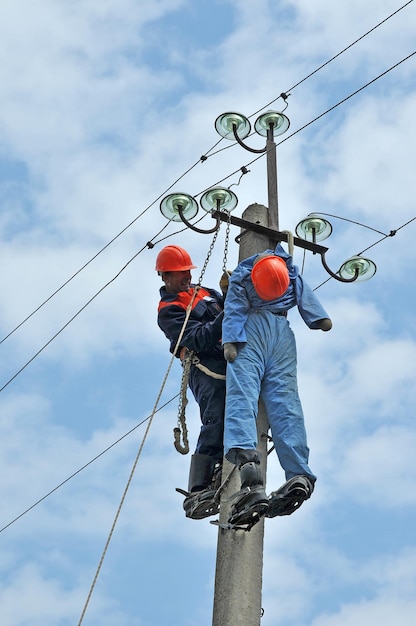 Pracownikowi dotkniętemu porażeniem prądem pomaga elektryk. Trening na manekinie.