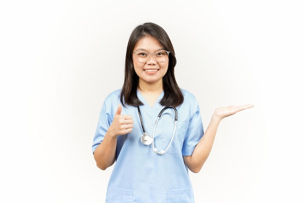 Prezentacja i pokazywanie produktu na otwartej dłoni azjatyckiego młodego lekarza na białym tle