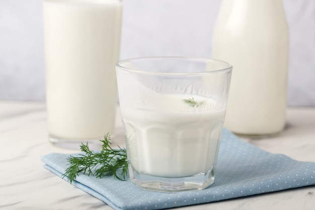 Produkty mleczne, koncepcja zdrowia, w naczyniach szklanych, na jasnoszarym tle, z bliska
