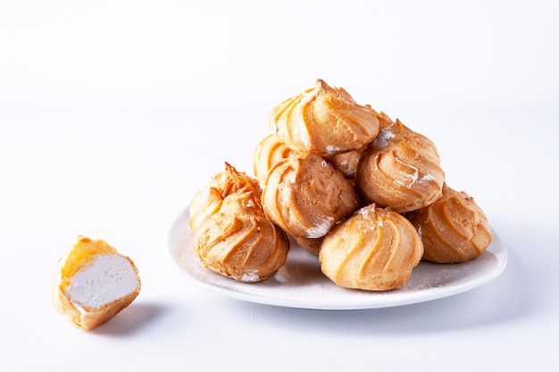 profiteroles z kremem na białym talerzu