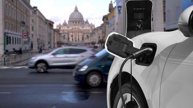 Progresywny samochód elektryczny ładujący akumulator na stacji ładowania w Watykanie historyczny kościół chrześcijański w centrum miasta Samochód EV połączony z punktem ładowania za pomocą wtyczki kablowej