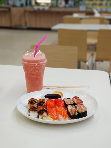 Przekąska w strefie gastronomicznej centrum handlowego. Sushi na talerzu.