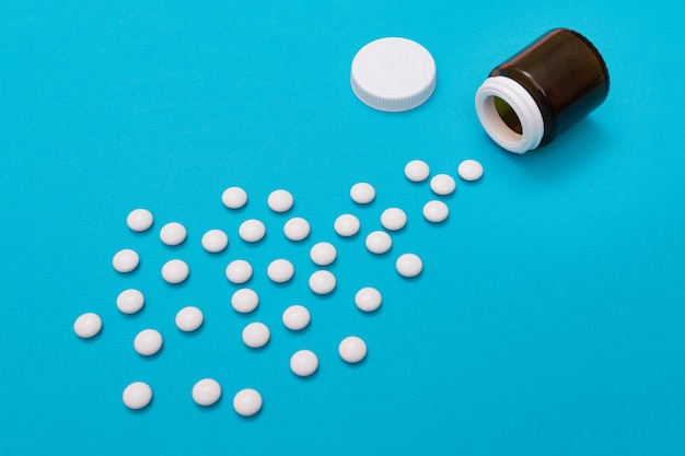 Przemysł farmaceutyczny i produkty lecznicze białe tabletki na niebieskim tle