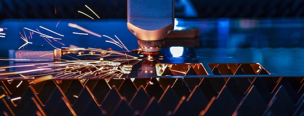 Przemysłowa maszyna do cięcia laserowego podczas cięcia blachy z iskrzącą, lekką stroną banera