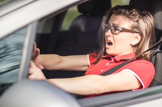 Zdjęcie przestraszona dziewczyna kierowca honking, aby uniknąć wypadku drogowego