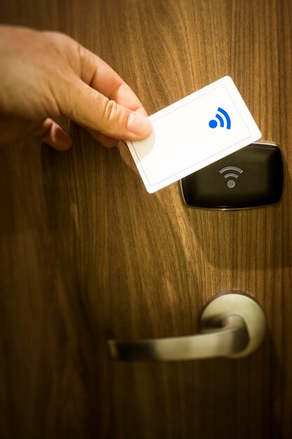 Przycięta ręka osoby otwierającej drzwi hotelu