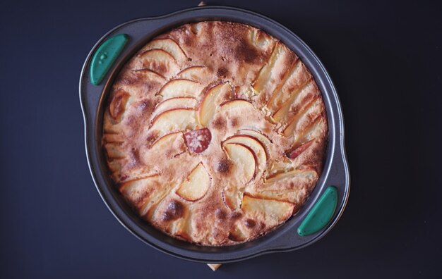 Zdjęcie przygotowanie szarlotki w domu. domowe wypieki z jabłkami i orzechami. słodki deser z pieczonych jabłek.
