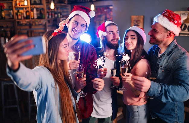 Przyjaciele świętują razem Nowy Rok Przyjaciele z drinkami na koktajlu