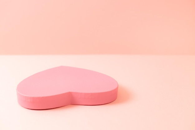 Pudełko na prezent w kształcie serca na różowym tle