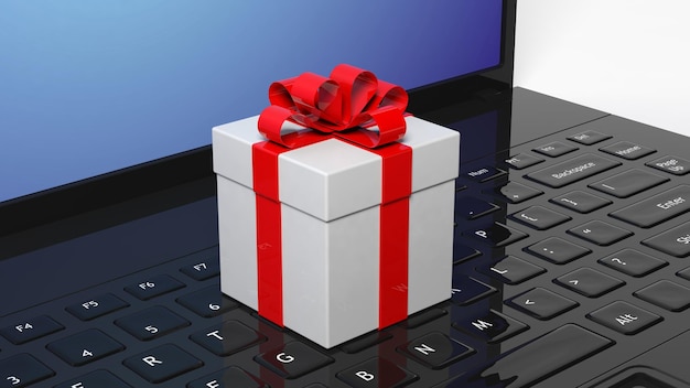 Zdjęcie pudełko z czerwoną wstążką na czarnej klawiaturze laptopa