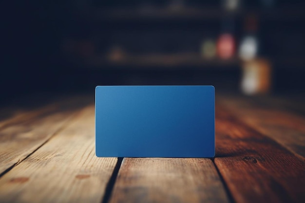 Zdjęcie pusta wizytówka na niebieskiej książce na drewnianym stole