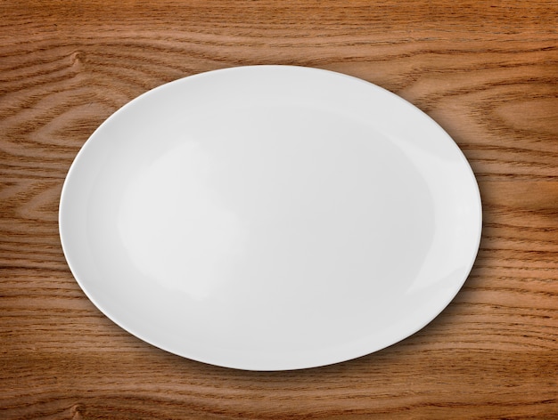 Pusty biały talerz na drewnianym stole