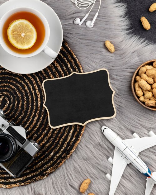 Pusty drewniany znak ze starym aparatem natychmiastowym, samolotem i herbatą