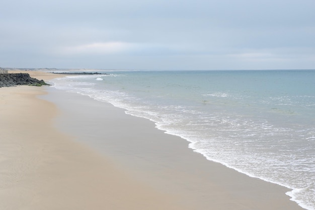 Pusty oceaniczny krajobraz plaży o wyblakłych, spokojnych kolorach we Francji