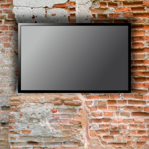 Pusty telewizor na ścianie z cegły z miejscem na kopię