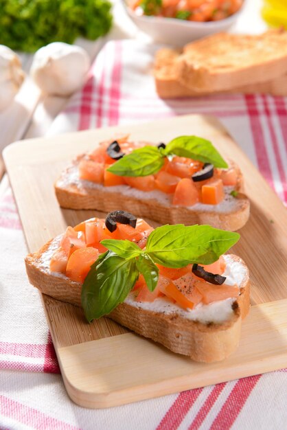 Pyszna bruschetta z pomidorami na zbliżenie deski do krojenia