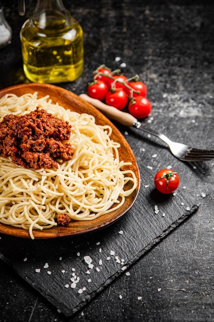 Pyszne spaghetti bolognese w misce z pomidorkami koktajlowymi