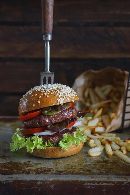 Pyszny Podwójny Burger Z Frytkami Na Ciemnym Tle, Klimatyczna Restauracja, Fotografia Kulinarna