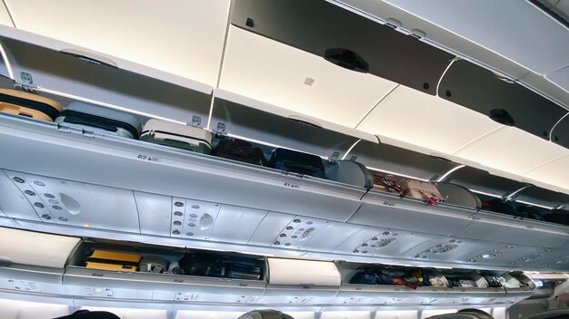Rafa bagażowa z bagażem w samolocie Wnętrze samolotu Koncepcja podróży