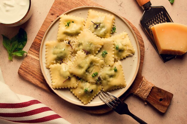 Ravioli ze szpinakiem i serem wegetariańskie jedzenie na beżowym tle bez ludzi selektywne skupienie rustykalne