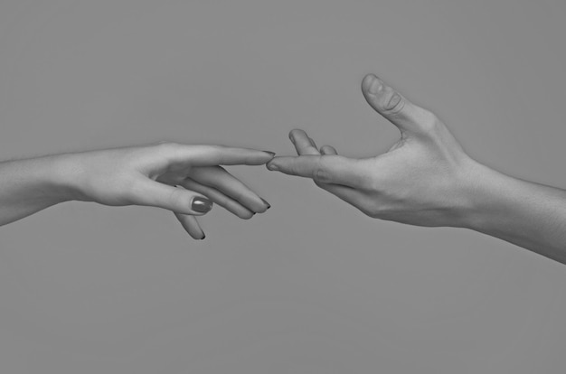 Zdjęcie reaching touching hands reach hand sensual touch fingers two hands trying to touch hands of man and woman reaching to each other hand try to touch fingers touch each other sensual arm